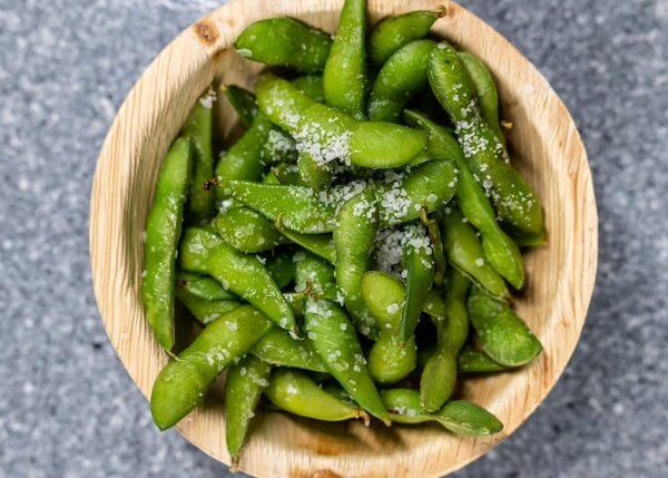 Salted edamame in a palm-leaf bowl
