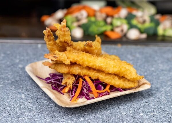 Crispy shrimp tempura on shredded cabbage and carrot