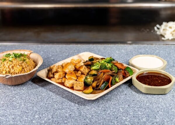 Hibachi chicken with broccoli, zucchini and onions, fried rice and two sauces