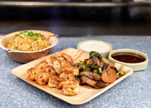 Hibachi shrimp with mushrooms and carrots, fried rice and two sauces