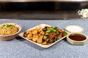 Hibachi chicken with broccoli, zucchini and onions, fried rice and two sauces